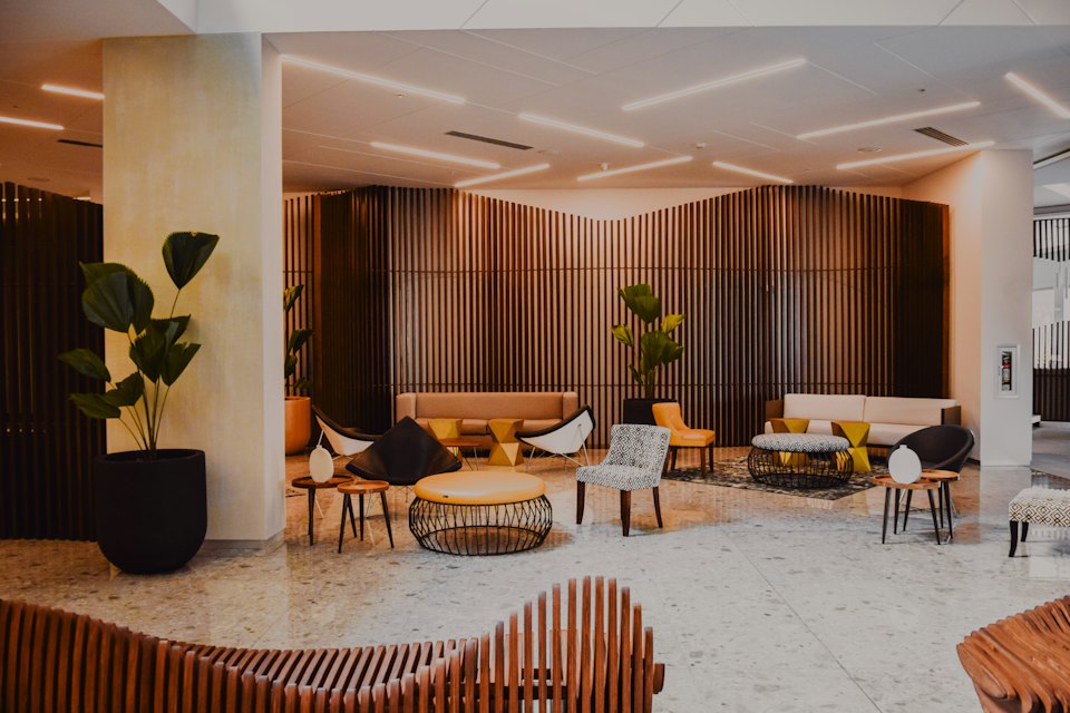 Modern hotel lobby with designer furniture and timber walls