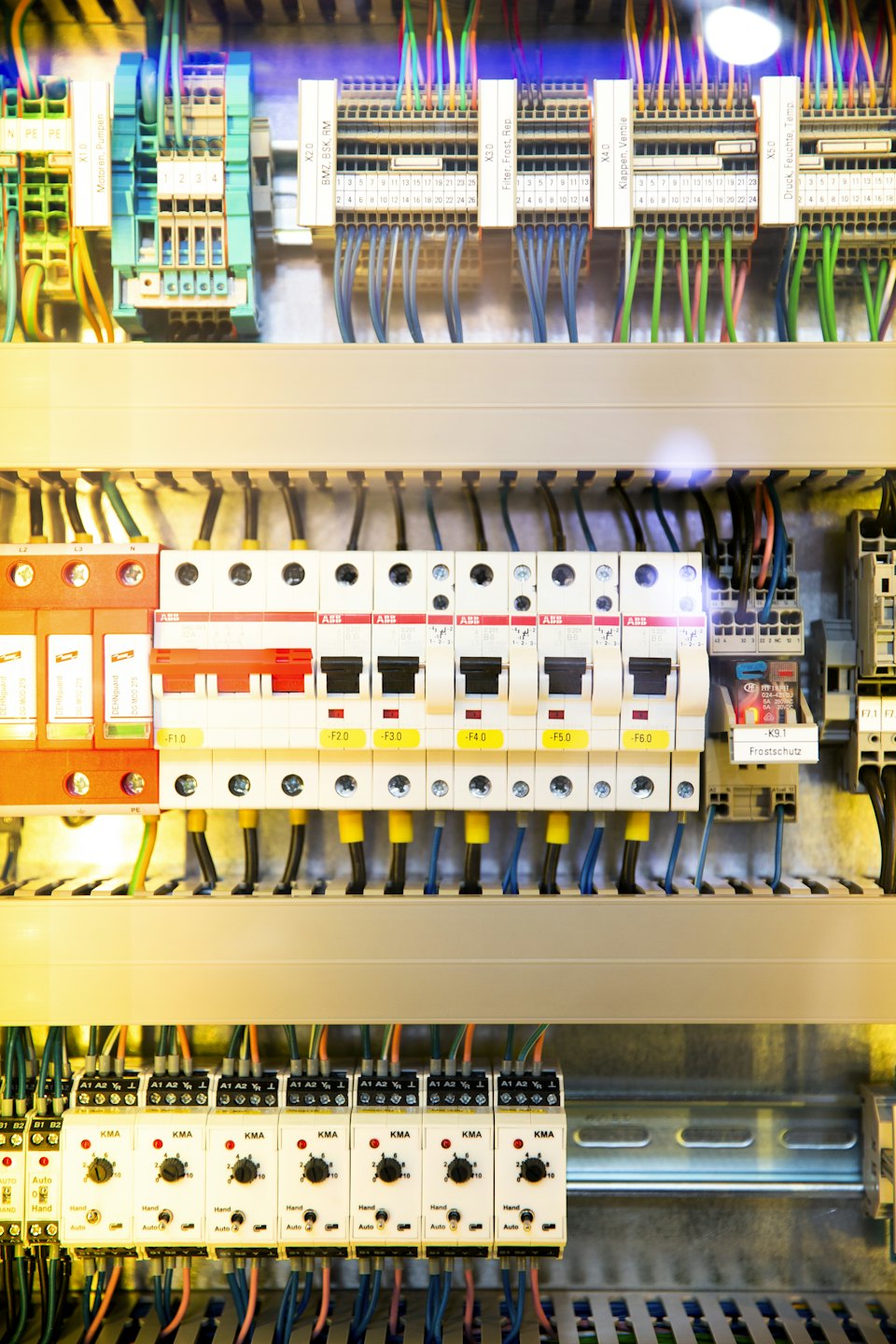 Open electrical distribution board with circuit breakers and wiring