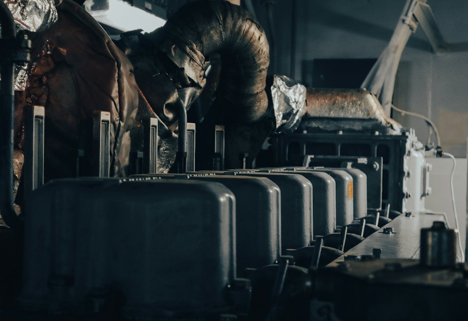 Engineer working on pumps and pipework in a plant room