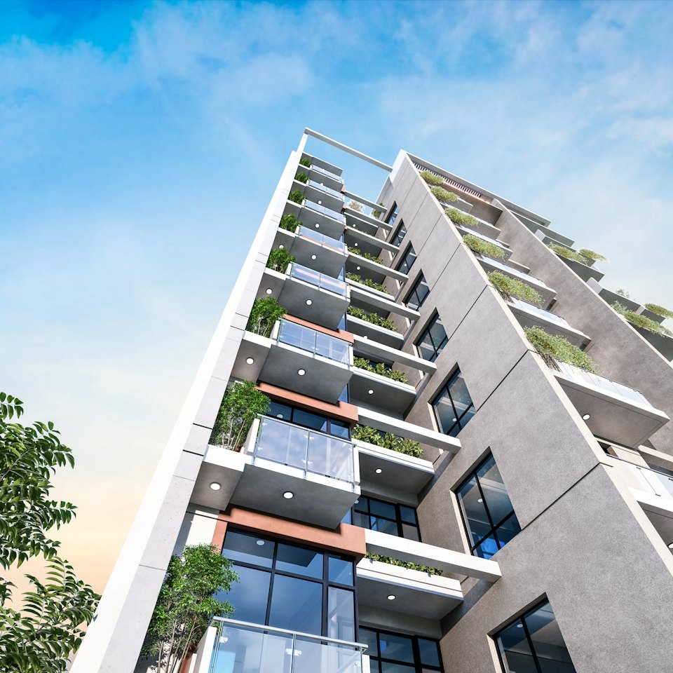 Modern apartment building with balconies and greenery