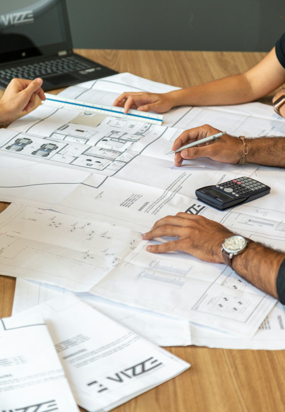 Engineers reviewing architectural drawings on a desk