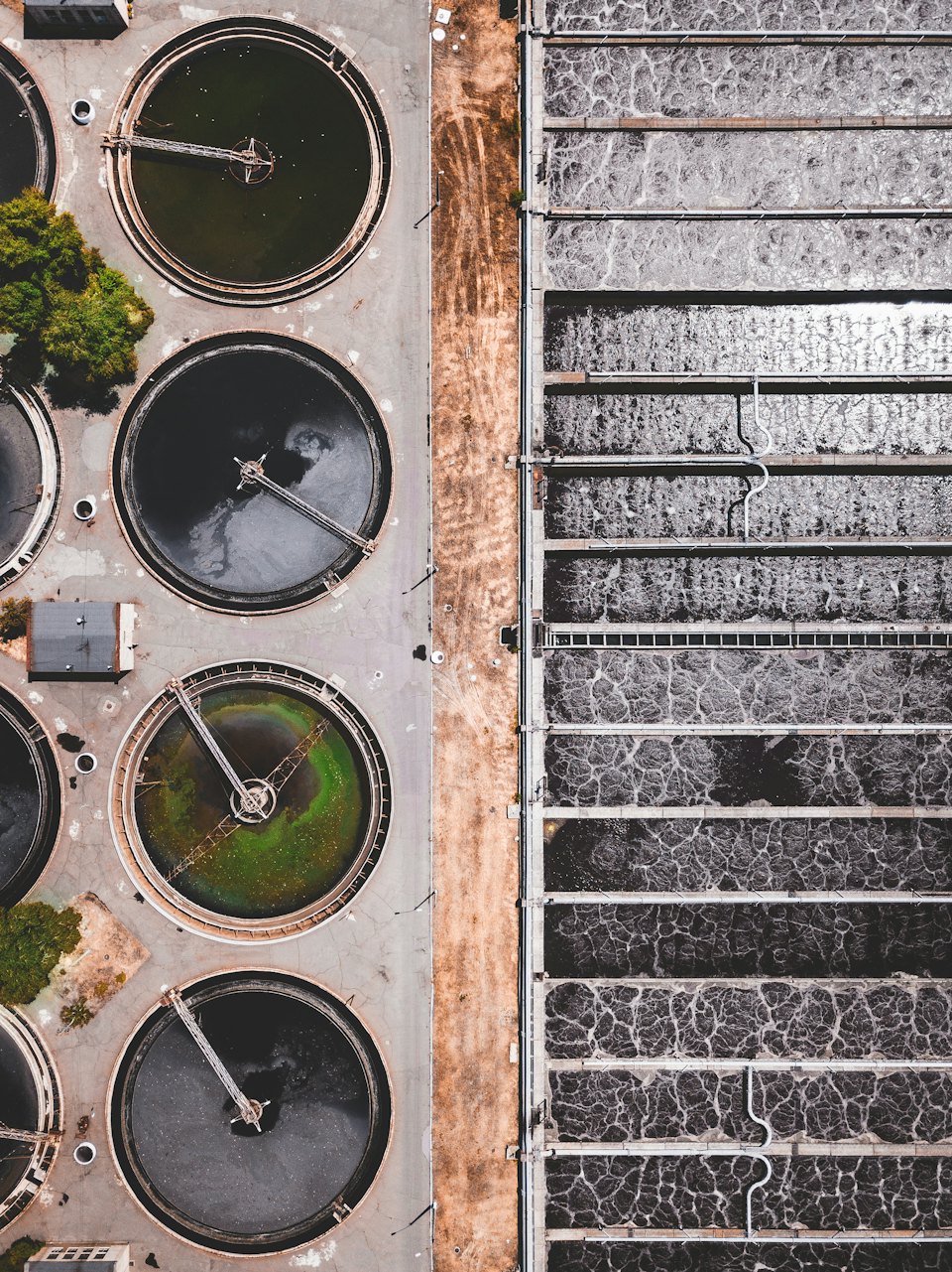 Aerial view of circular and rectangular tanks at a water treatment facility